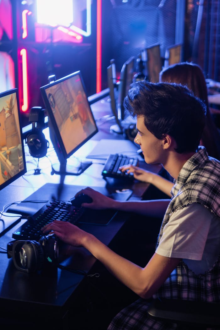 Man in Plaid Shirt Using Computer